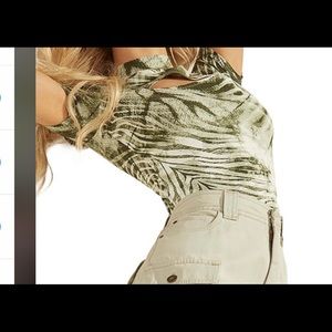Guess top features a mock neck and cut out detail across the chest.